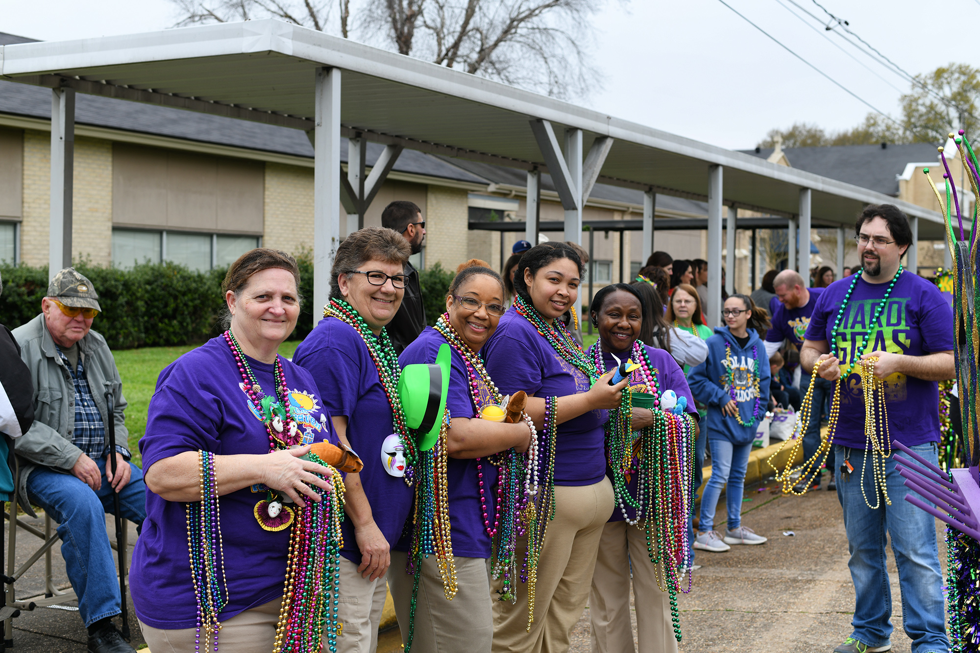 Our Lady of Prompt Succor School in Alexandria held their annual Pre-K Mardi Gras Parade on Mar. 1.  The entire student body, faculty and parents line up to catch beads and trinkets as the Pre-K classes parade down 21st Street in front of the school. Also participating were the Penny Kings, Queen, Prince, and Princess from Fall Festival, and the 2018 ReProm King and Queen.
OLPS Staff laissez les bons temps rouler!
